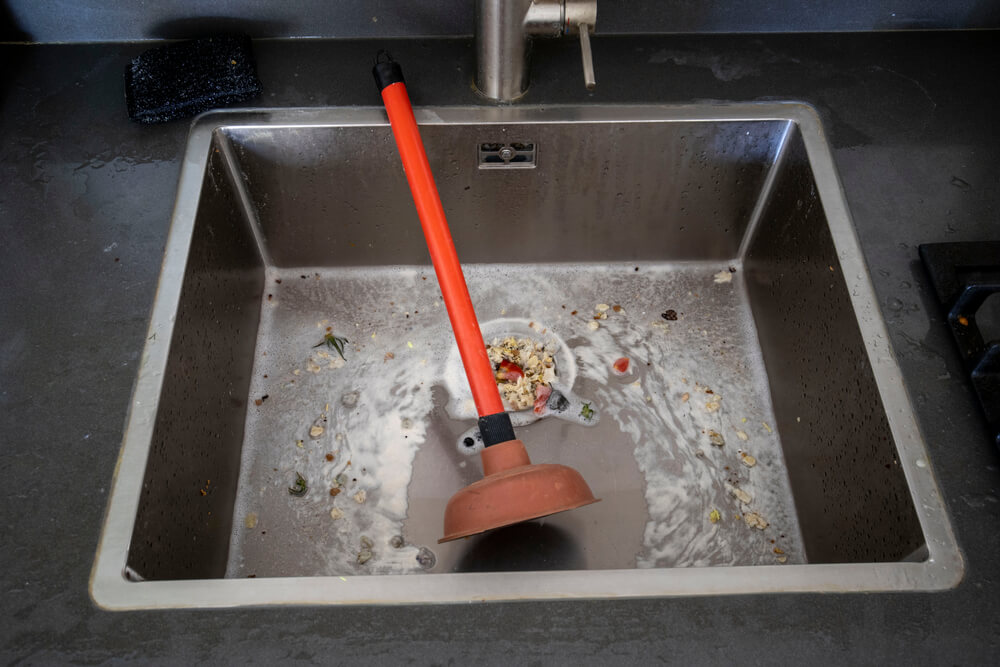 clogged kitchen sink with plunger